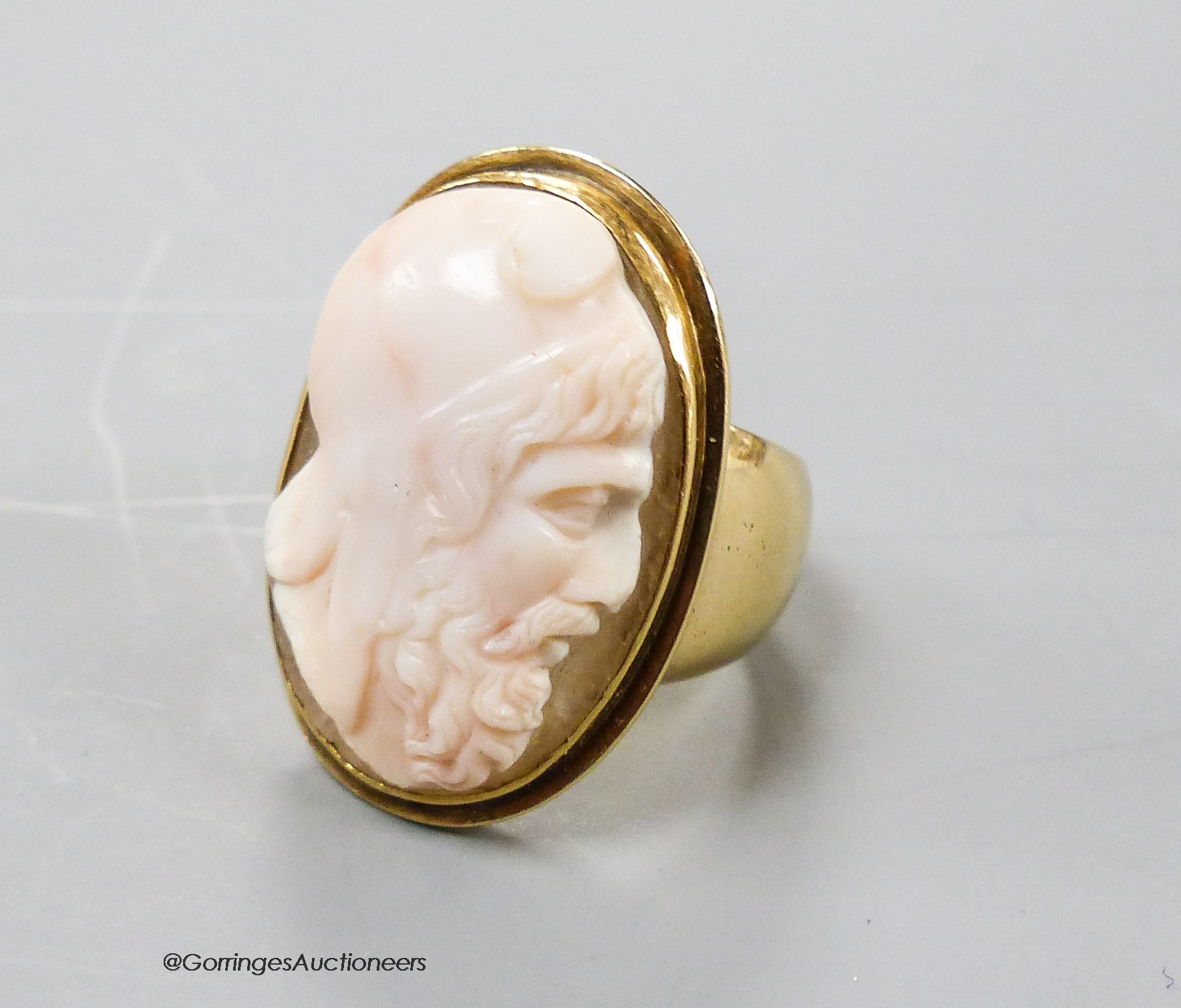 An antique yellow metal and oval cameo quartz? ring, carved with head of a gentlemen to sinister, size K, gross 13.2 grams.